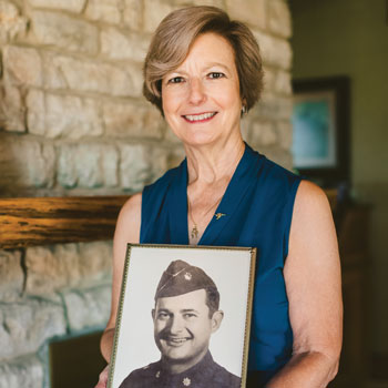 Mary Taylor Henderson holding a photo of her father